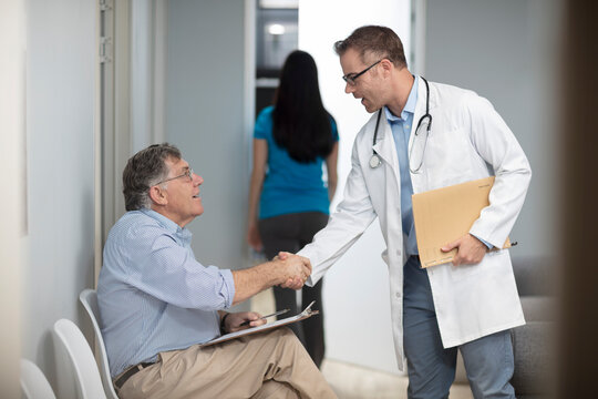 Doctor shaking hands with patient in medical practice