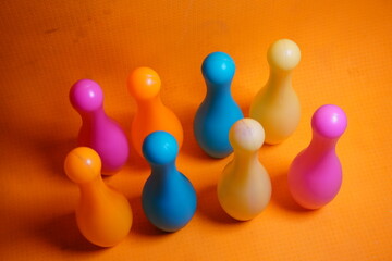 Obraz premium Bright colorful plastic bowling pin toys for children, promoting indoor fun, coordination skills, and playful learning activities.