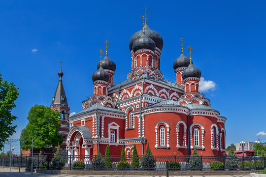 Holy Resurrection Cathedral in Borisov, Belarus three quarter rear view. Sunny sky over red brick orthodox church apse