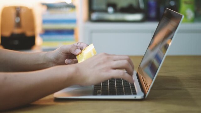 Closeup of Businessman Hands Hold Filling credit card information for Online Payment on Laptop Screen, E-commerce Checkout and Internet Banking Concept. 