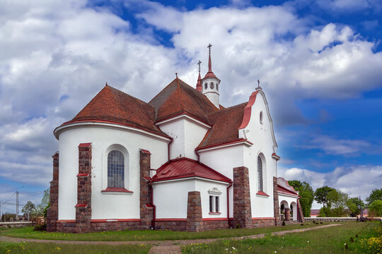 Church of Our Lady of the Rosary in Soly, Belarus three quarter rear view. Partly cloudy sky over Art Nouveau catholic apse