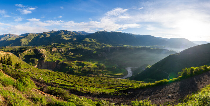 Panoramic sunrise view over the ancient green agricultural terraces in the Colca Valley, Peru
