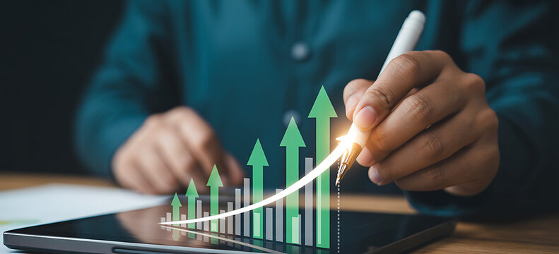 Hand using digital pen on tablet to draw glowing green bar chart with upward arrows representing data analysis visualising financial analytics and technological business innovation.