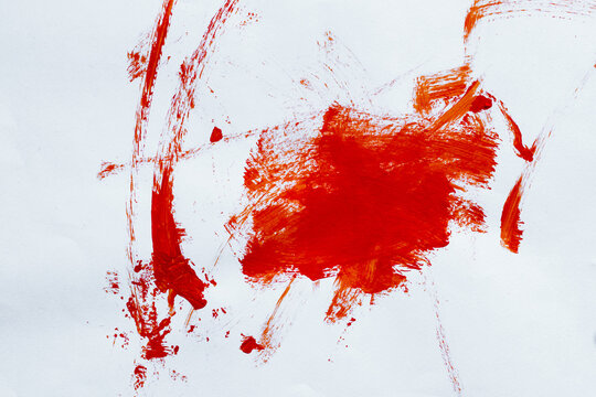 Bold red paint brush strokes on white paper