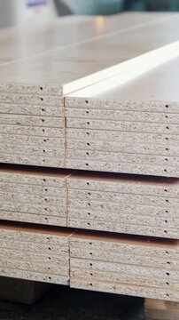 Stack of wood particleboard panels on the warehouse or factory