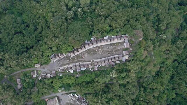 Aerial view of Bena Traditional Village with its iconic thatched roofs nestled in the lush jungle of Kecamatan Jerebuu, Nusa Tenggara Timur, Indonesia.