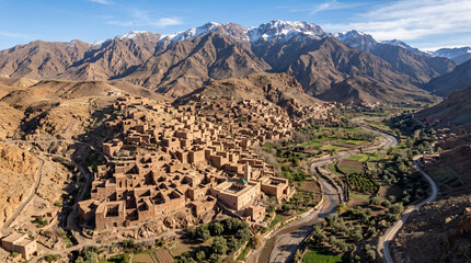 Aerial view of Houses of clay at the foot of the mountains. Old berber architecture in High Atlas Mountains region in Morocco.   © pinan