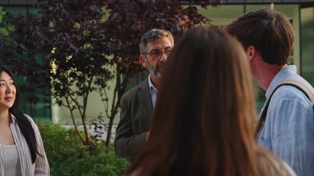 Group of University Students talking with Professor, brainstorming, sharing ideas, and opinions in Modern Uni Campus