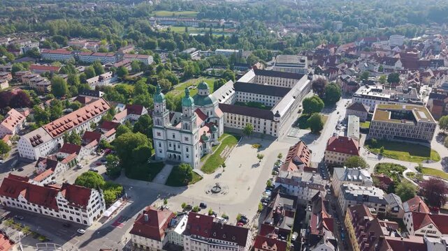 Wide aerial drone view of Basilica Saint Lorenz Church and the historic Kempten Allg&auml;u city center in Germany, showcasing Bavarian architecture and the urban landscape from above. UHD.
