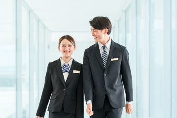 Fototapeta premium Young Asian businesspeople in suits (hotel staff, planners, bankers, consultants)