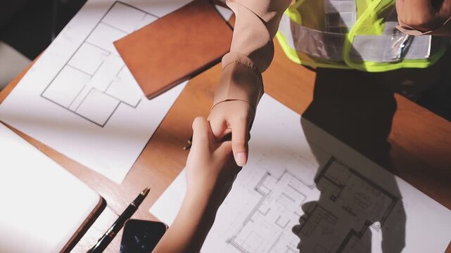 professional architect designer structural engineer team colleagues working office looking computer discussing building plan design project.