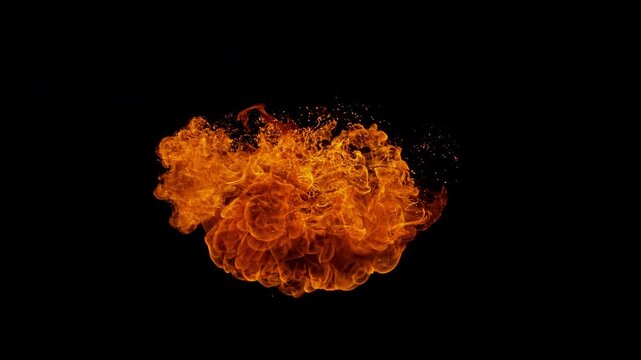 Small fire explosion with glowing sparks and embers isolated on a black background. Dynamic flames and combustion effects captured in high detail for dramatic visual impact.