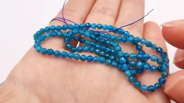 These vibrant blue apatite stone beads feature a multifaceted cut on durable stringing wire for creating elegant custom jewelry, professional artisan accessories, and intricate craft projects