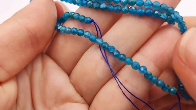 These vibrant blue apatite stone beads feature a multifaceted cut on durable stringing wire for creating elegant custom jewelry, professional artisan accessories, and intricate craft projects