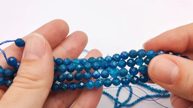 These vibrant blue apatite stone beads feature a multifaceted cut on durable stringing wire for creating elegant custom jewelry, professional artisan accessories, and intricate craft projects
