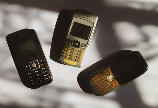 Vintage Mobile Phones and Outdated Technology - Set of Three Old Cell Phones for E-Waste Concept