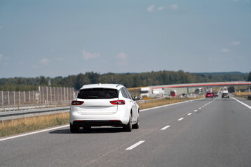 Fototapeta premium Estate car traveling on a clear highway road