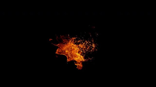 Small fire explosion with glowing sparks and embers isolated on a black background. Dynamic flames and combustion effects captured in high detail for dramatic visual impact.