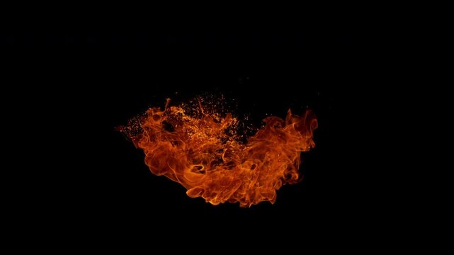 Small fire explosion with glowing sparks and embers isolated on a black background. Dynamic flames and combustion effects captured in high detail for dramatic visual impact.