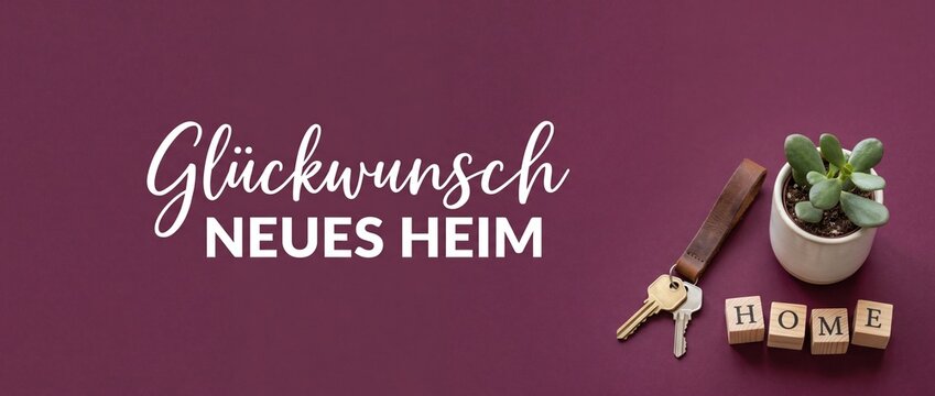 New home house keys card with German text Gl&uuml;ckwunsch Neues Heim on burgundy flat lay background with small succulent plant and wooden blocks for housewarming celebration and apartment relocation bann