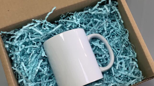 Mug. DIY box. Ceramic mug. Cardboard box. Slow motion video.. High quality 4k footage