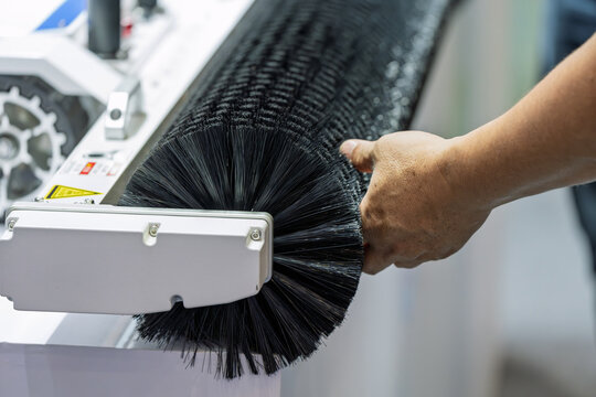 Workers debug cleaning brush roller equipment