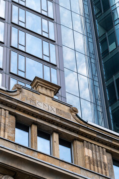 A historic stone frontage below Frankfurt, Germany glass towers shows modern financial architecture rising over an urban facade contrast