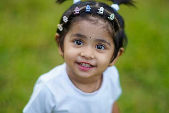 Cute indian little girl child posing outdoor