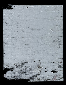 torn white paper scrap isolated on a black background. Features rough ripped edges, distressed surface details, worn paper texture, and authentic imperfections. 