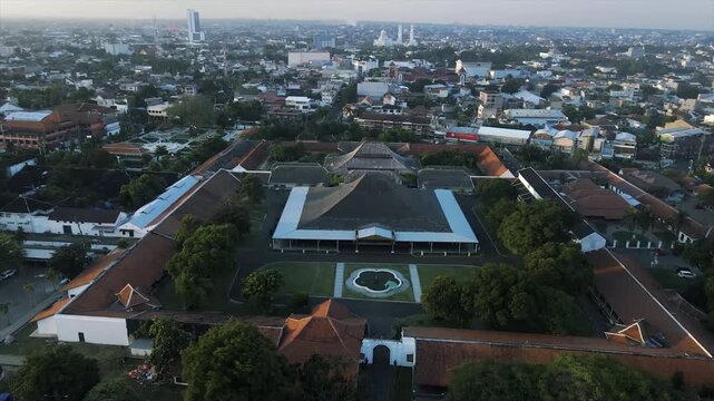 Aerial 4k view of the historic Yogyakarta Kraton palace complex and the surrounding city skyline.
