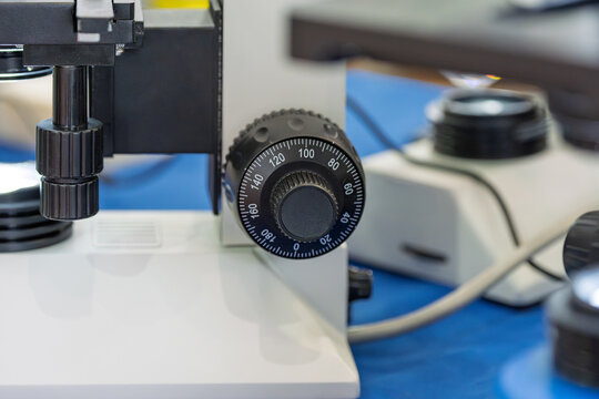 Close up of adjustment knobs on laboratory microscope