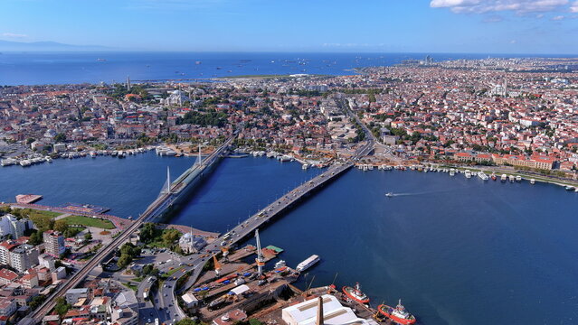 4K aerial drone view of Istanbul, Turkey. Panoramic cityscape featuring the Golden Horn, Hali&ccedil; Metro Bridge, Atat&uuml;rk Bridge, and Marmara Sea.