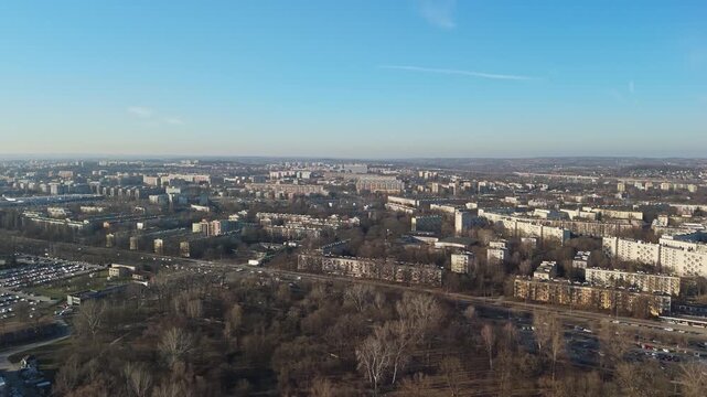 In Nowa Huta, Krak&oacute;w, a planned residential district features mid‑century apartment blocks, wide streets, and leafless trees seen from a drone over its socialist realist urban layout.
