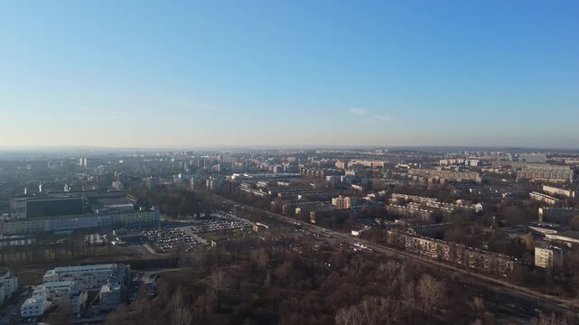 In Nowa Huta in Krak&oacute;w, Poland, dense residential blocks form a mid-century urban landscape with visible street hierarchy, winter trees, and parking areas seen in an aerial view.