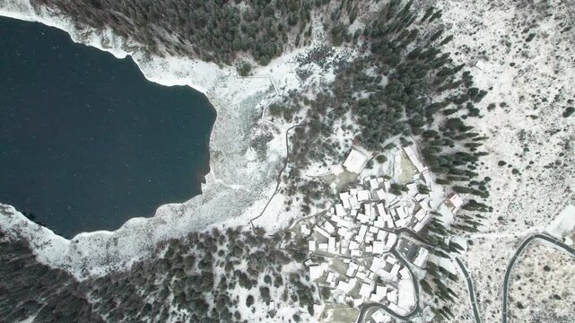 Drone view of lover sea, Changhaizi or qingrenhai, alpine glacial lake in Jinchuan, Aba, northwest Sichuan, China, white snow flakes flying upwards due to landing, 4k real time footage, travel concept