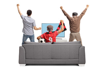 Obraz premium Rear view shot of a group of excited men watching football on tv and cheering