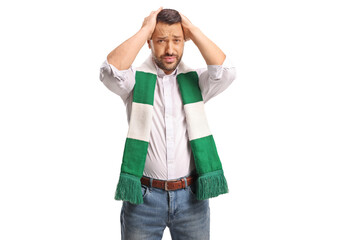 Fototapeta premium Disappointed football fan holding his head in disbelief after a loss