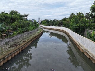 Fototapeta premium An aerial view highlights the vibrant city with its beautiful Jakarta canals and lush greenery, showcasing urban architecture in harmony with nature for a captivating landscape.