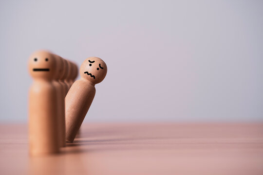 Wooden figures showing anxiety and social isolation, representing stress, emotional pressure, mental health issues, workplace burnout, loneliness, insecurity, and psychological challenges.
