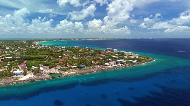 North West Point, Cayman Islands: Aerial view of turquoise Caribbean sea, tropical coastline and reef off Grand Cayman - landscape panorama from above
