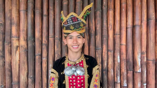 Young man smiling with complete set of Dusun Tindal Clothes Sinipak during Kaamatan Harvest Festival in Sabah Malaysia