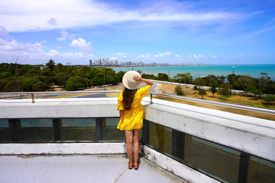 Tourism in Joao Pessoa, Brazil. Rear view of young woman in Estacao Cabo Branco belvedere, Joao Pessoa, Brazil.