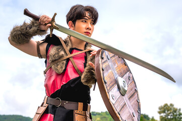 Obraz premium Male ancient warrior in full armor holding sword and shield, ready for battle