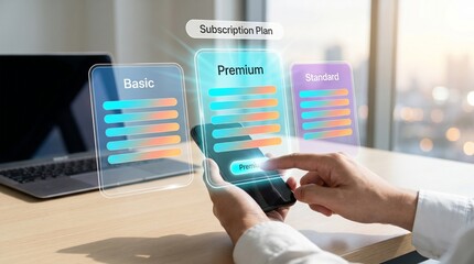 Person comparing saas pricing subscription plans on smartphone and laptop in office © Sadia