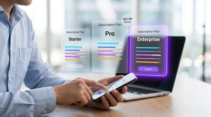 Businessman analyzing saas pricing plans on laptop and smartphone in modern office © Sadia