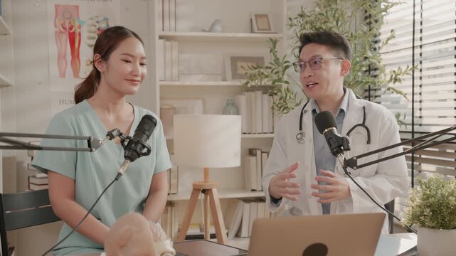 Male doctor and female nurse or therapist discussing health topics while recording educational medical podcast or live streaming a webinar. Healthcare professionals content creator influencer concept.