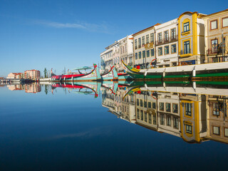 Traditional moliceiro boats docked along the central canal in Aveiro, Portugal