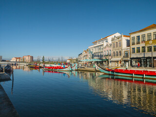 Traditional moliceiro boats docked along the central canal in Aveiro, Portugal © volff