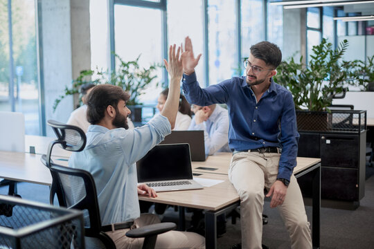 Two men are shaking hands in a business setting