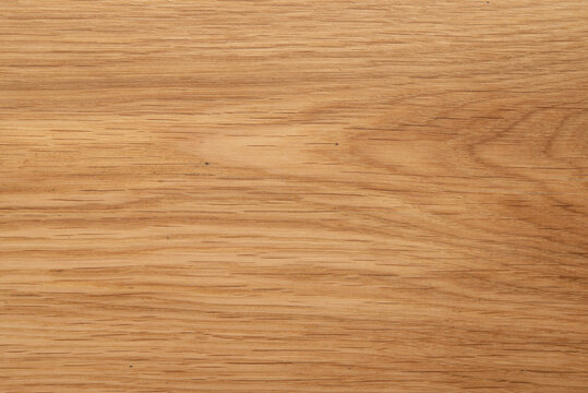 Natural oak wood texture background, light brown wooden board surface with organic grain pattern.
